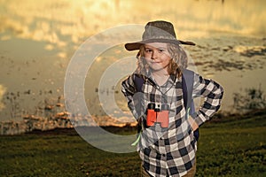 Child with backpack, traveller or explorer. Concept of exploration and discovery. Kid travel on nature outdoors