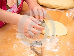 Child baking cookies in christmas time