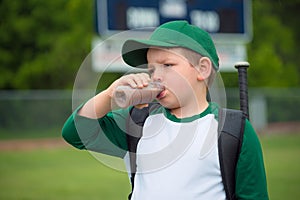 Child baseball player drinking chocolate milk