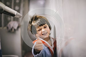 Child after the bath comes he dries his hair photo