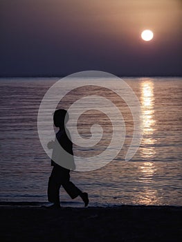 Child on the beach running at sunset home