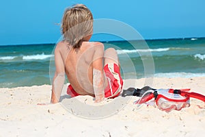 Child on beach with snorkel