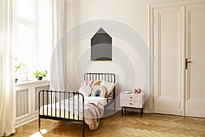 Child bedroom interior with a single bed, window and blackboard on a wall