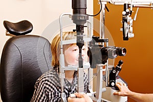 Child behind a Slit Lamp for eye testing