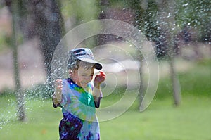 Child being sprayed by water