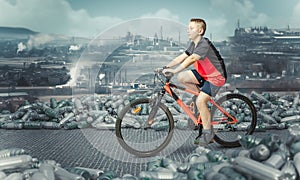 child on bicycle amid mountains of bottles background