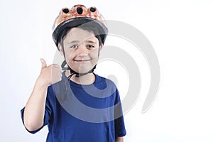 Child in a bicycle helmet shows gesture OK