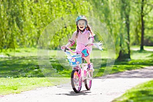 Child on bike. Kids ride bicycle. Girl cycling.