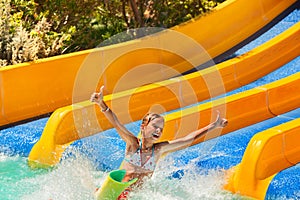 Child in bikini sliding water park