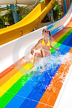 Child in bikini sliding water park