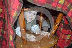 Child in blanket fort