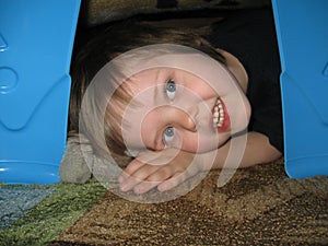 Child in blanket fort