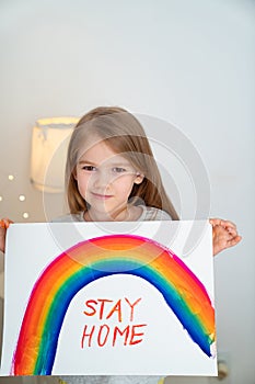 Child drew rainbow and poster stay home. photo