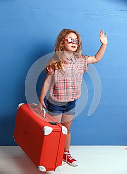 Child blonde girl with pink vintage suitcase ready for summer vacation. Travel and adventure concept