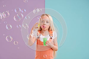 Child, blowing bubbles and playing in studio as holiday activity for leisure, childhood development or mockup space