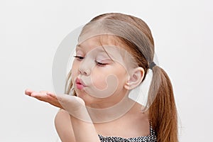 Child blowing on palm