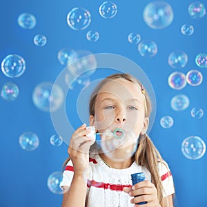 Child blowing soap bubbles