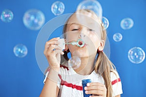 Child blowing soap bubbles