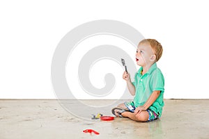 Child blowing soap bubbles in white background