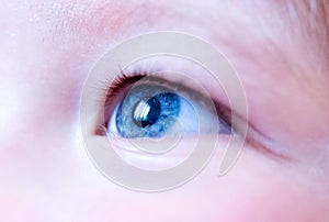 Child with blue eye looking up