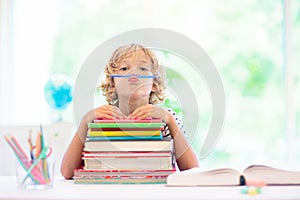 Child with books doing homework after school