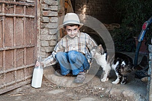 Child with bottle of cow's milk straight from the cow