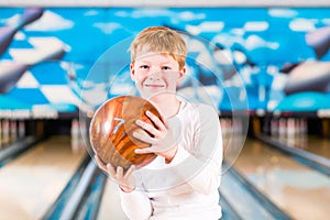 Child bowling with ball