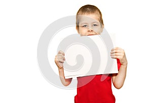 A child, a boy 5 years old, holds sheets of paper on isolated white background