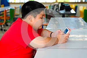 Child Boy are addictive playing tablet and mobile phones