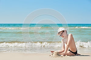 Child boy on beach. Rest on vacation, play in sand against sea. Tourism and vacation on ocean. Family vacation in summer. Vacation