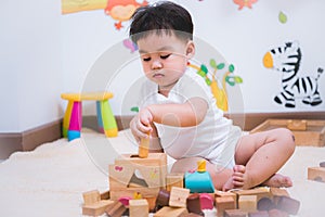 Child boy building playing toy blocks wood
