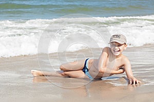 Child boy cheerful on beach