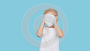 Child boy covered his face with a protective mask. The concept of strengthening quarantine during the coronavirus pandemic.