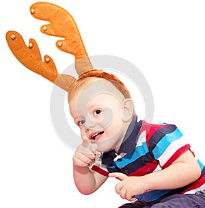 The child, the boy, with deer horns for a New Year's masquerade