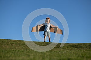 Child boy dreams and travels. Boy with airplane toy outdoors. Happy child playing with toy airplane outdoors in summer