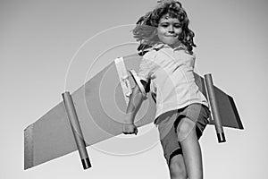 Child boy dreams and travels. Boy with airplane toy outdoors. Happy child playing with toy airplane outdoors. Travel