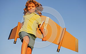 Child boy dreams and travels. Boy with airplane toy outdoors. Happy child playing with toy airplane outdoors. Travel