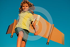 Child boy dreams and travels. Boy with airplane toy outdoors. Happy child playing with toy airplane outdoors. Travel