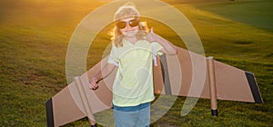 Child boy dreams and travels. Boy with airplane toy at sunset outdoors. Happy child playing with toy airplane outdoors