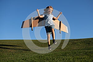 Child boy dreams and travels. Boy jumping and running with airplane toy outdoors. Happy child playing with toy airplane