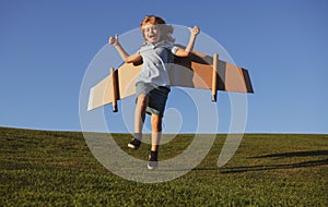 Child boy dreams and travels. Boy jumping and running with airplane toy outdoors. Happy child playing with toy airplane