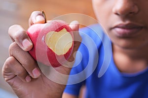 child boy eating apple close up