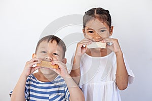 Child boy and girl eating bread together before go to school