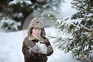 Child boy having fun in the snow