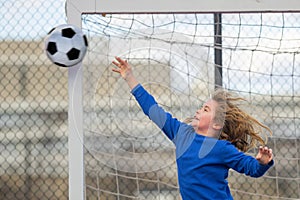 Child boy hold classic soccer ball on playground. Kid holding football ball in studio. Kid playing with ball. Sport