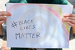 Child boy hold a paint draw for support black lives matter protest in usa,no racism