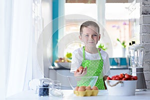 Child boy holding egg.