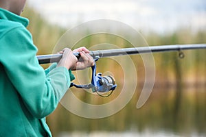child boy holds fishing rod