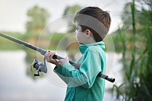 child boy holds fishing rod