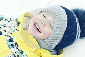 Child, boy, lies on the snow, blurred picture, emotions